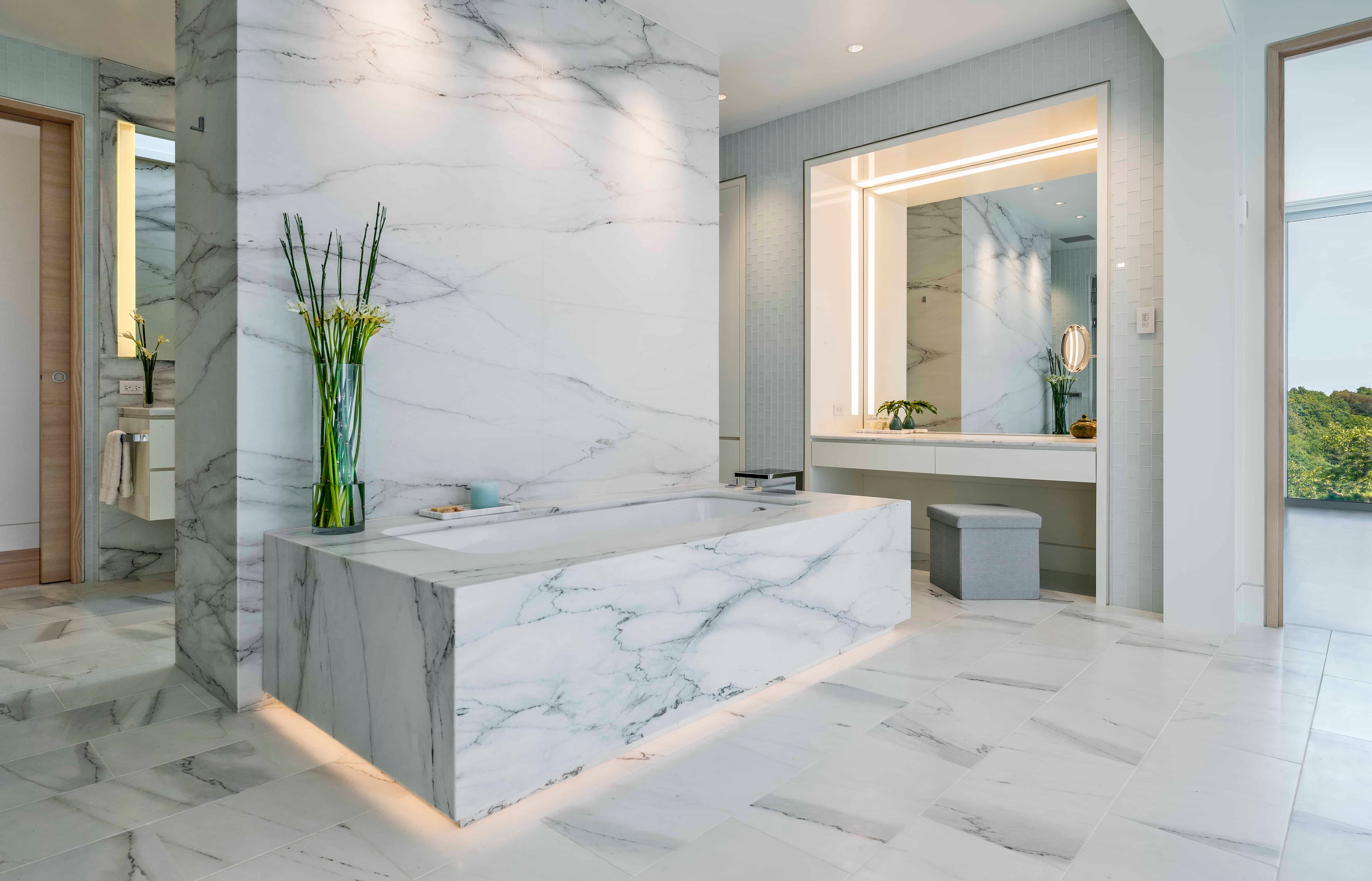 Luxury spa bathroom with marble-look surround and premium fixtures